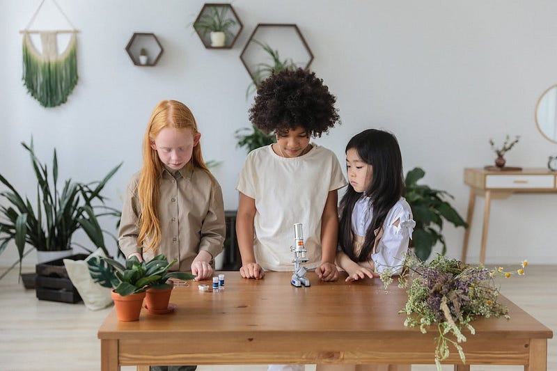 Diverse group of children exploring science at a table