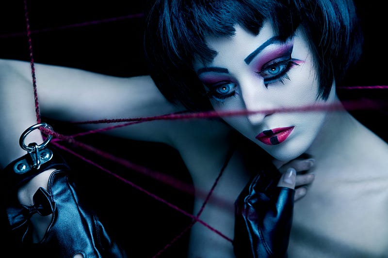 Woman in doll-like makeup with red ropes