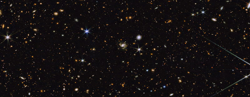 “This image depicts a field of hundreds of galaxies of various shapes, colors and sizes...”